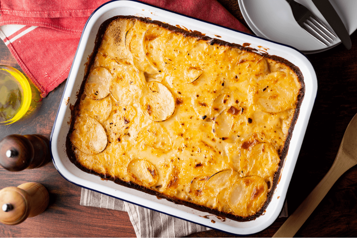 Golden-brown au gratin potatoes in a white baking dish