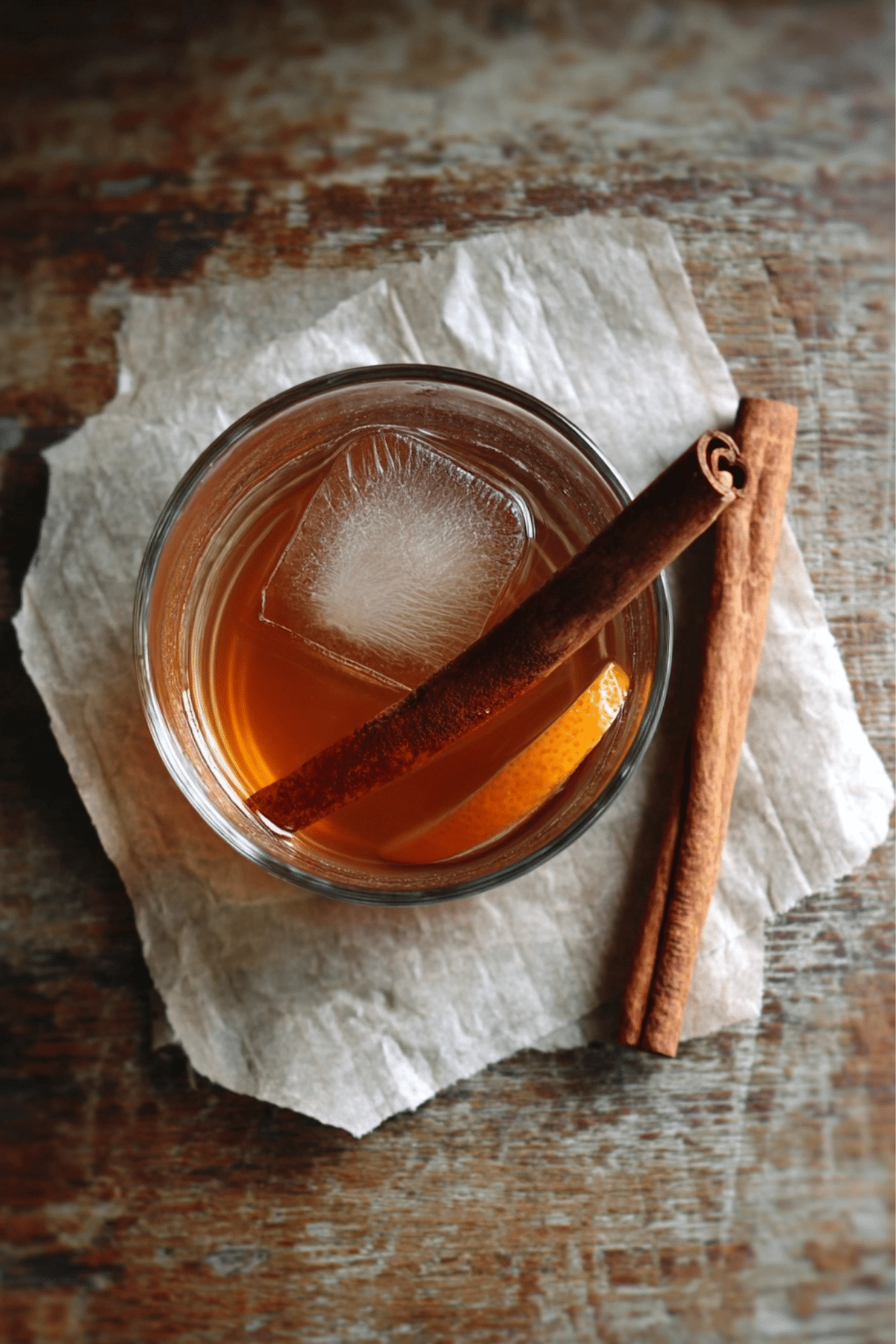 Cinnamon orange detox water in a glass with ice and cinnamon stick